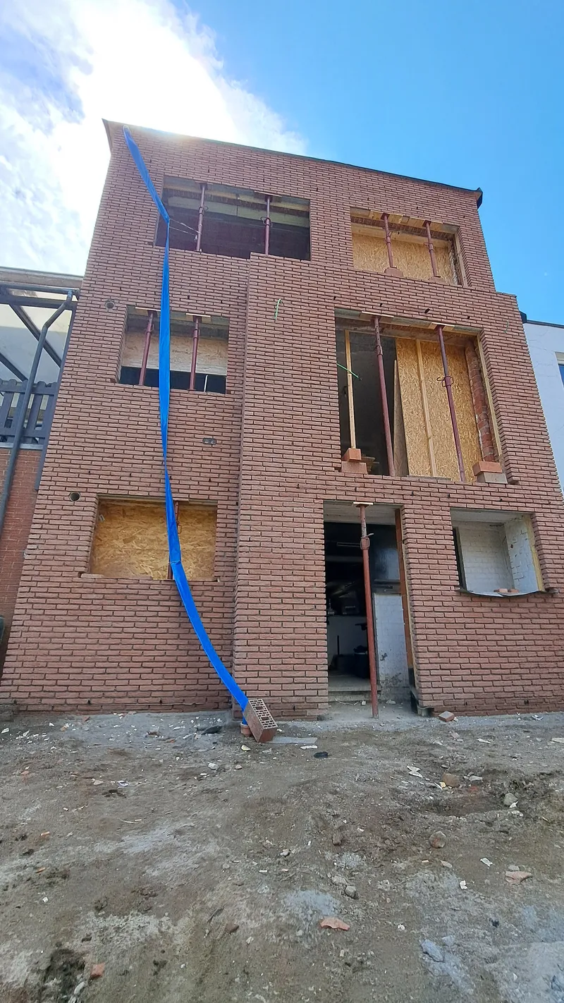 Na de metselwerken in Tremelo, afgewerkte scheidingsmuren met licht beige voegen en Rosado gevelsteen.